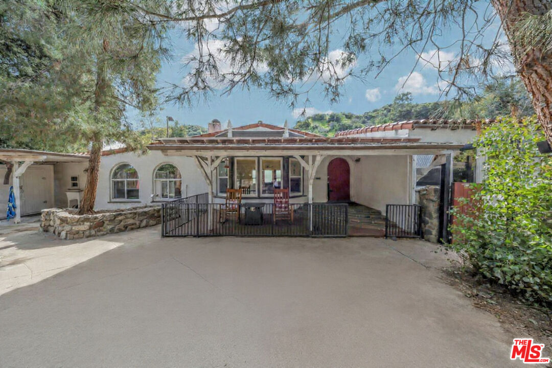 8600 La Tuna Canyon Road Sun Valley, CA 91352 - Photo 2 of 60 a view of a white house with a large tree and a yard