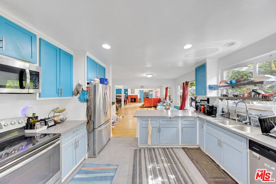 8600 La Tuna Canyon Road Sun Valley, CA 91352 - Photo 21 of 60 a kitchen with a sink stainless steel appliances cabinets and a counter top space