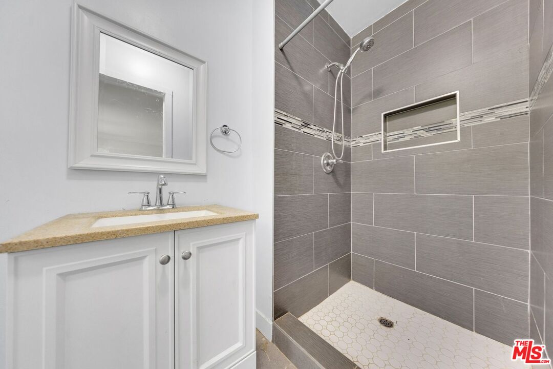 8600 La Tuna Canyon Road Sun Valley, CA 91352 - Photo 30 of 60 a bathroom with a shower sink and mirror