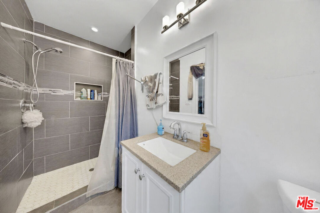 8600 La Tuna Canyon Road Sun Valley, CA 91352 - Photo 36 of 60 a bathroom with a sink a shower and a mirror