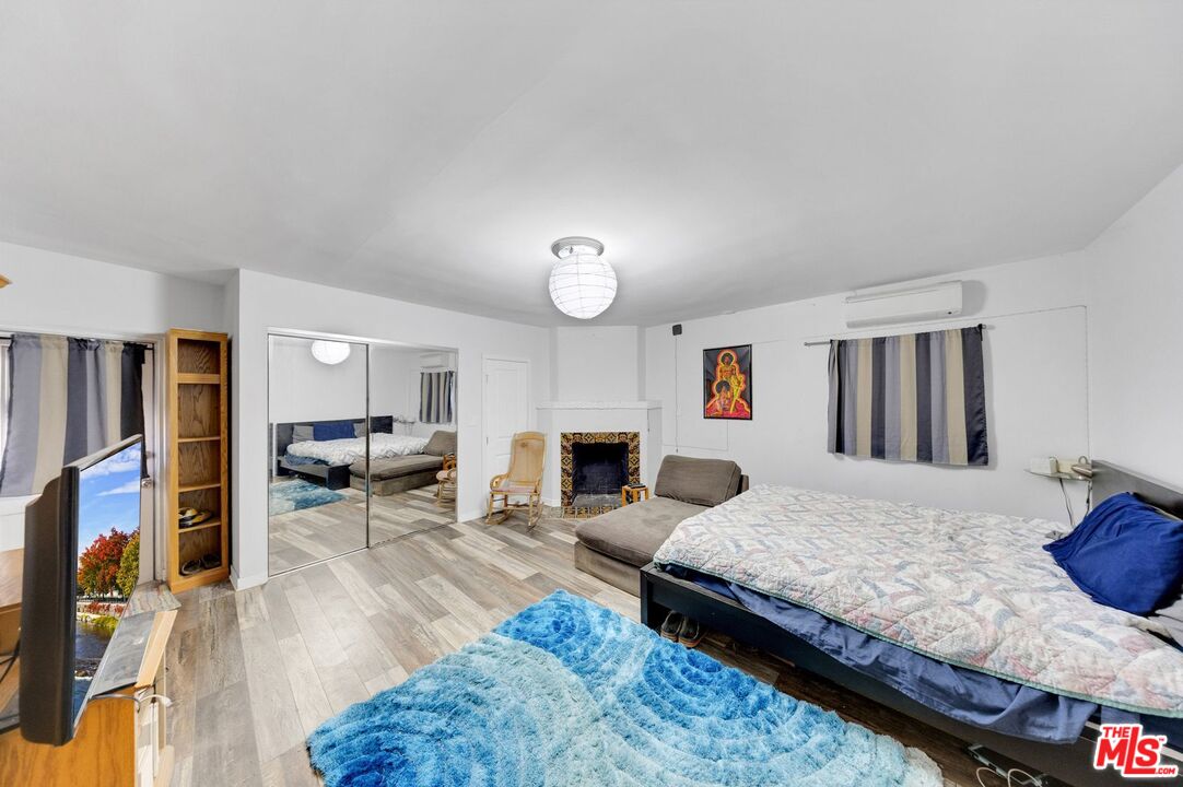 8600 La Tuna Canyon Road Sun Valley, CA 91352 - Photo 40 of 60 a bedroom with a bed a fireplace and dresser