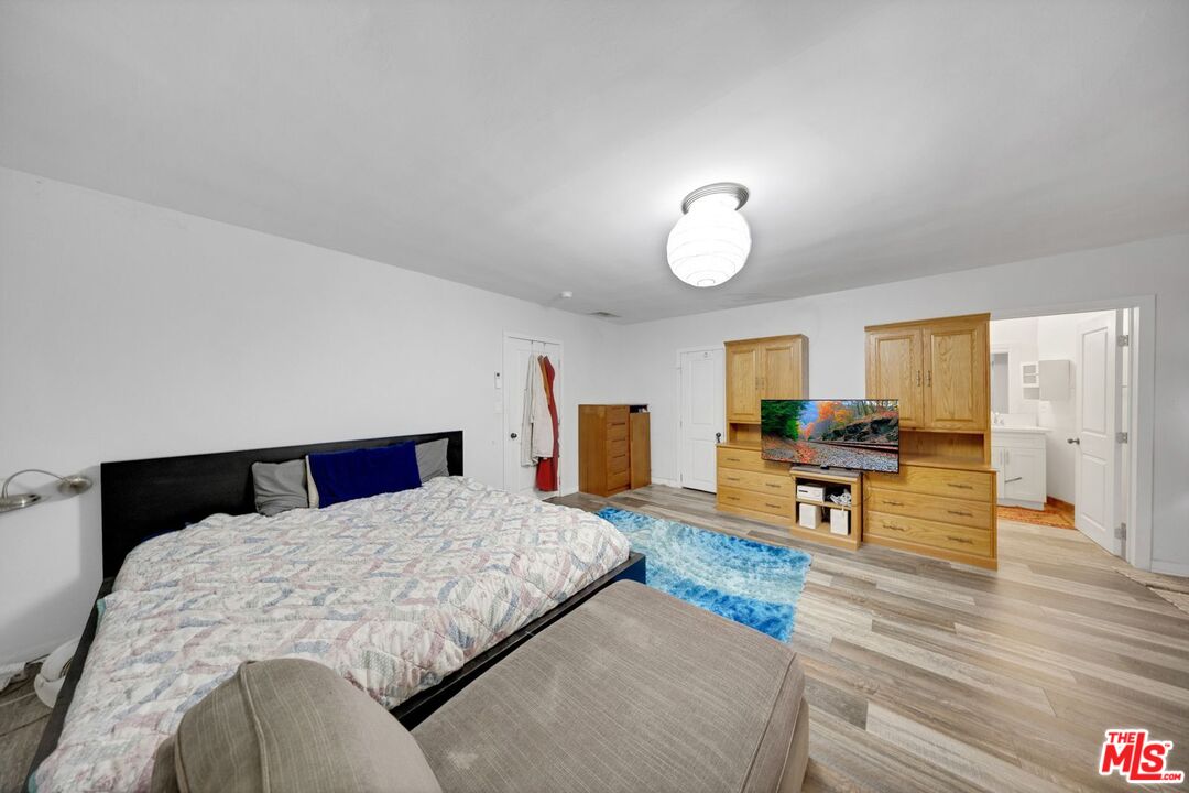 8600 La Tuna Canyon Road Sun Valley, CA 91352 - Photo 41 of 60 a bedroom with a large bed and a chandelier
