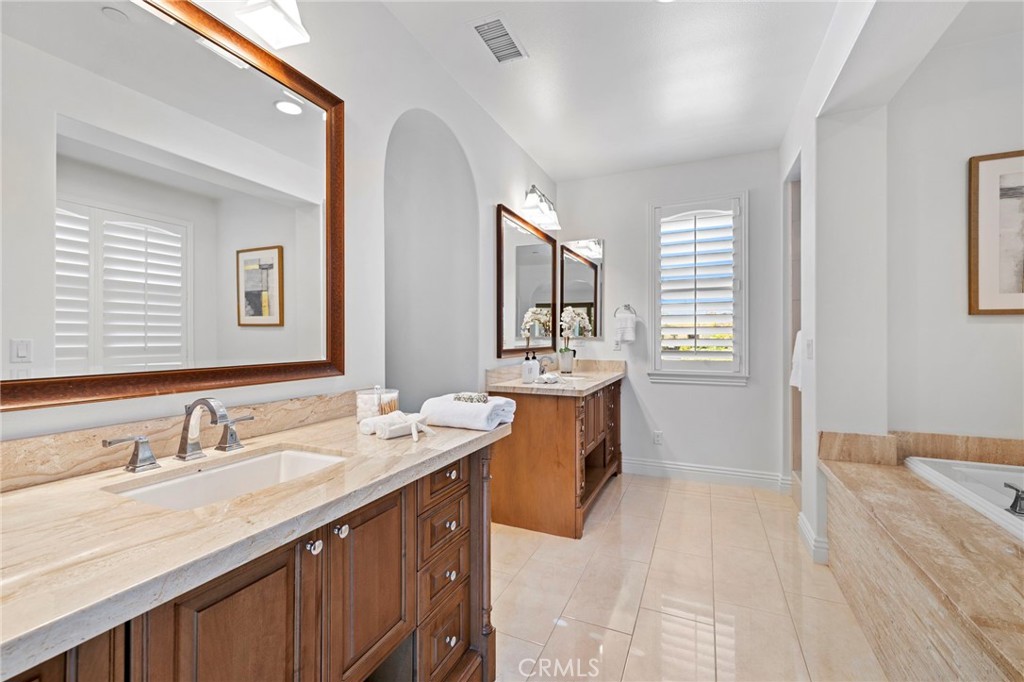 10 Gaucho Road Ladera Ranch, CA 92694 - Photo 19 of 52 a spacious bathroom with a double vanity sink a mirror and a bathtub