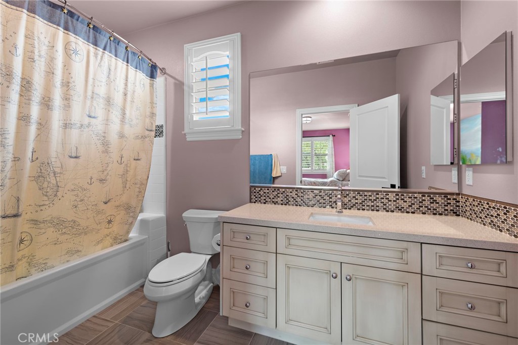 10 Gaucho Road Ladera Ranch, CA 92694 - Photo 26 of 52 a bathroom with a granite countertop sink a toilet and a large mirror