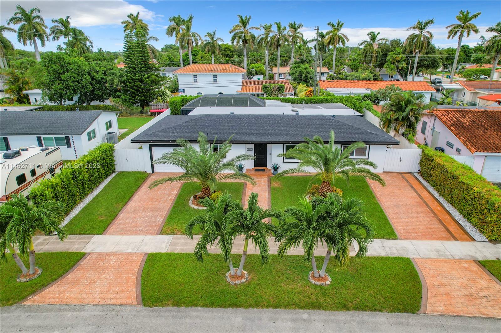 an aerial view of a house with swimming pool garden and patio