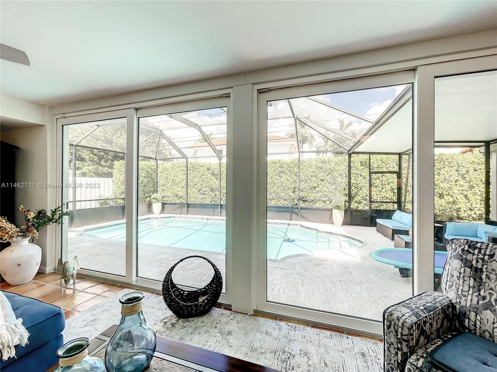 9035 Southwest 48th Terrace Miami, FL 33165 - Photo 15 of 37 a living room filled with furniture and a large window