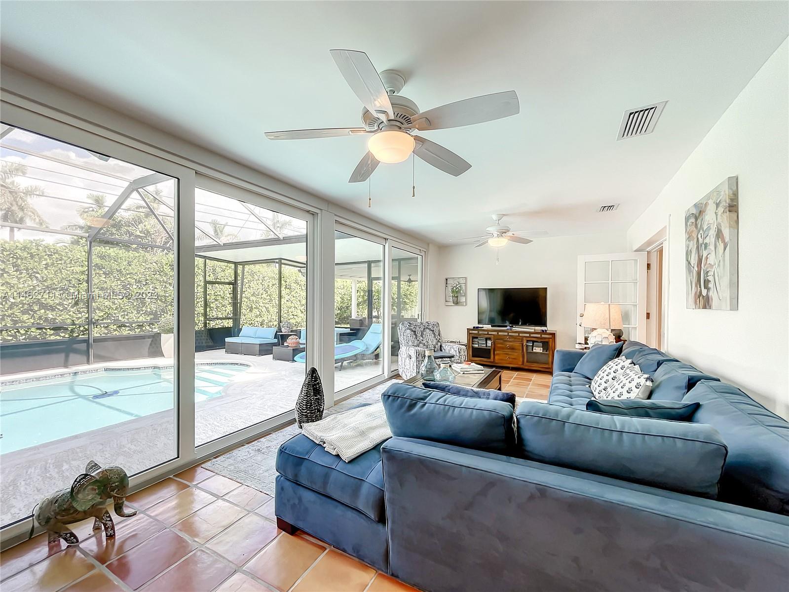 9035 Southwest 48th Terrace Miami, FL 33165 - Photo 16 of 37 a living room with furniture and a flat screen tv