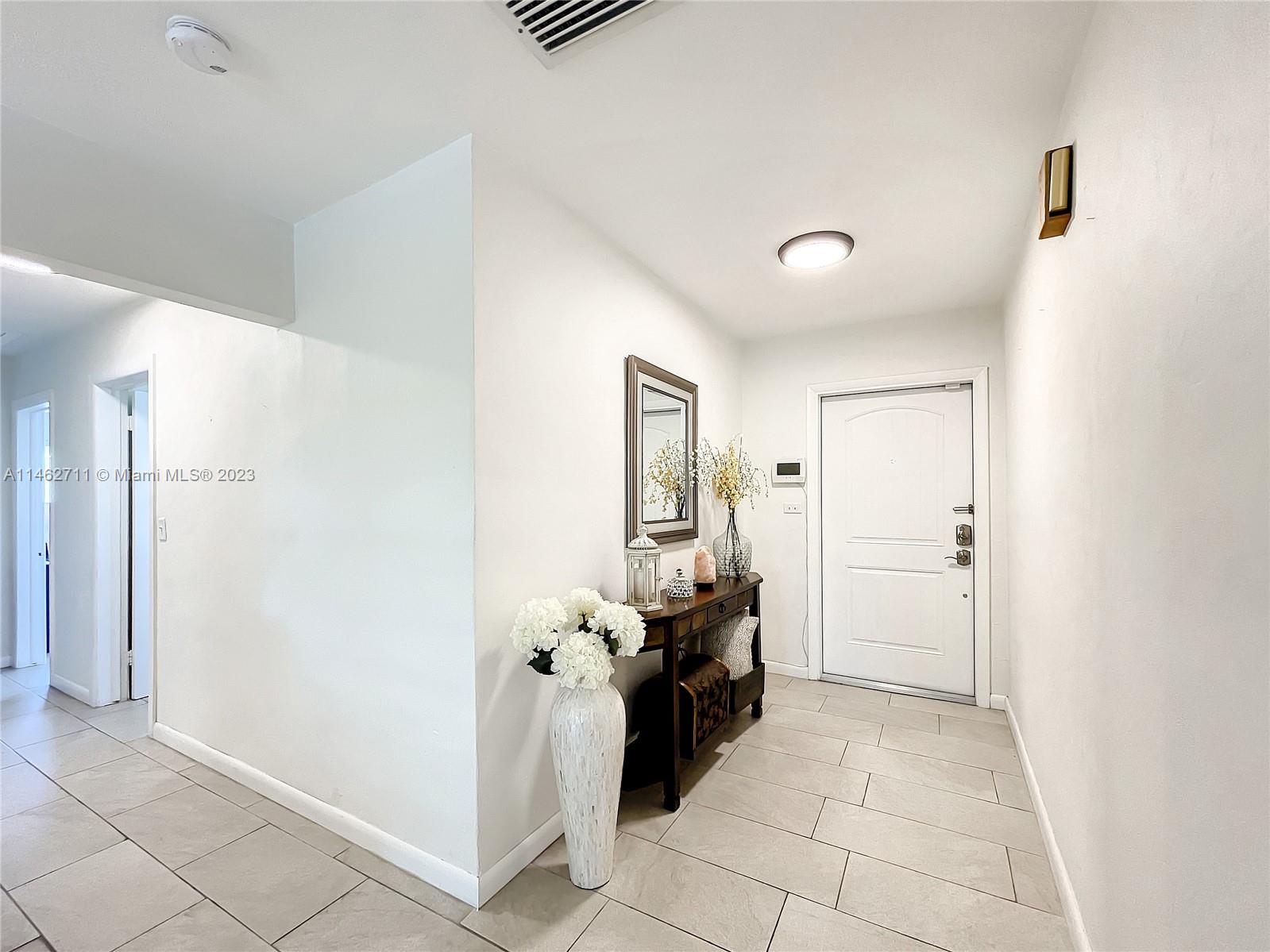 9035 Southwest 48th Terrace Miami, FL 33165 - Photo 2 of 37 a view of a hallway with bathroom