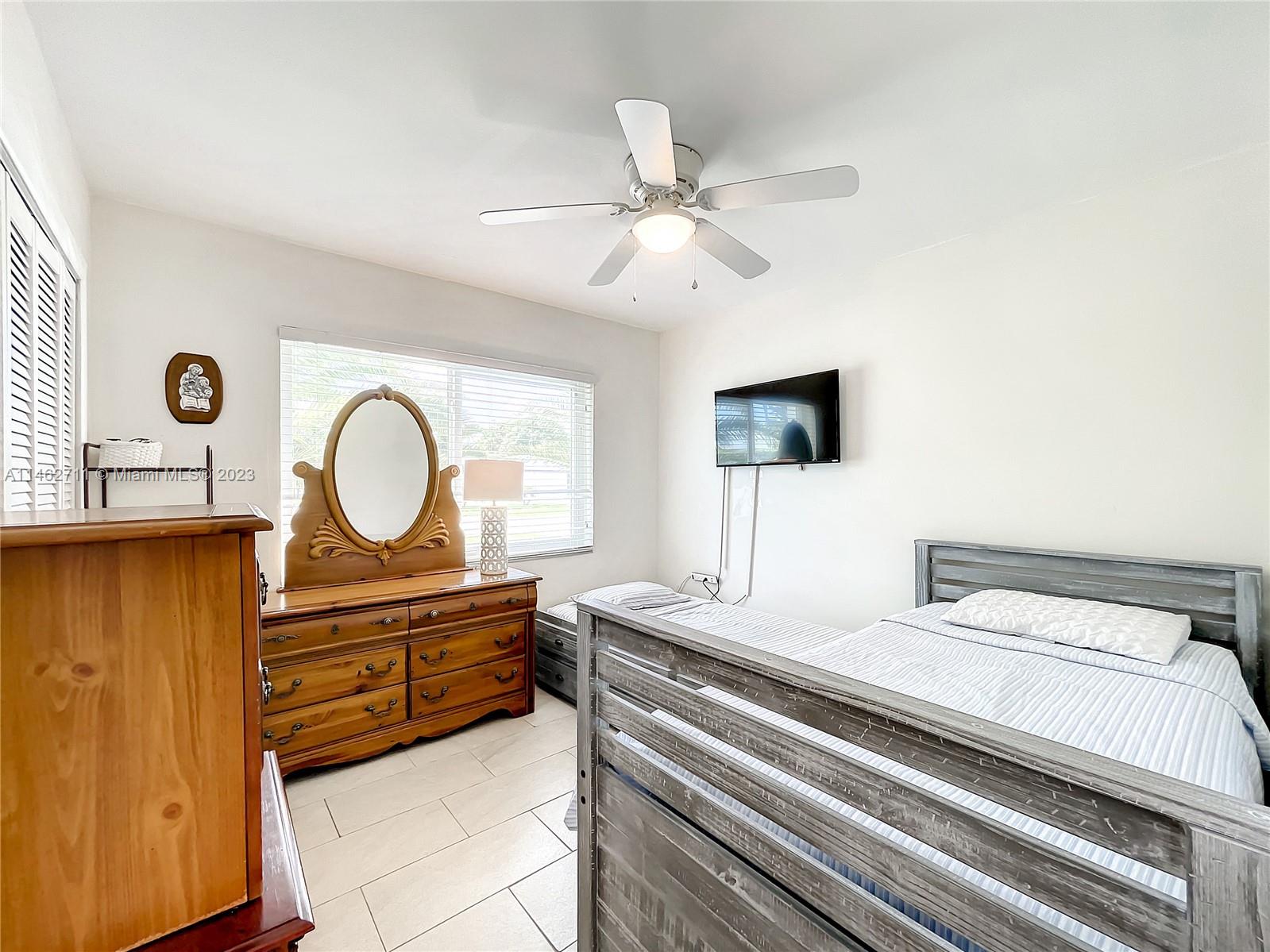 9035 Southwest 48th Terrace Miami, FL 33165 - Photo 23 of 37 a bedroom with a bed and a chandelier