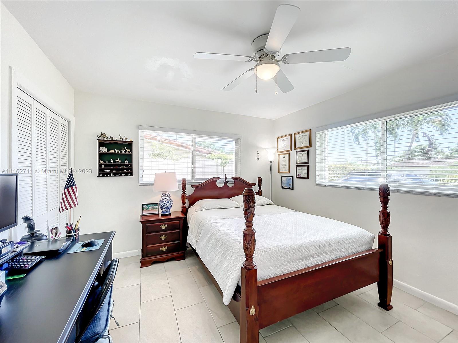 9035 Southwest 48th Terrace Miami, FL 33165 - Photo 24 of 37 a bed room with a bed window and a table