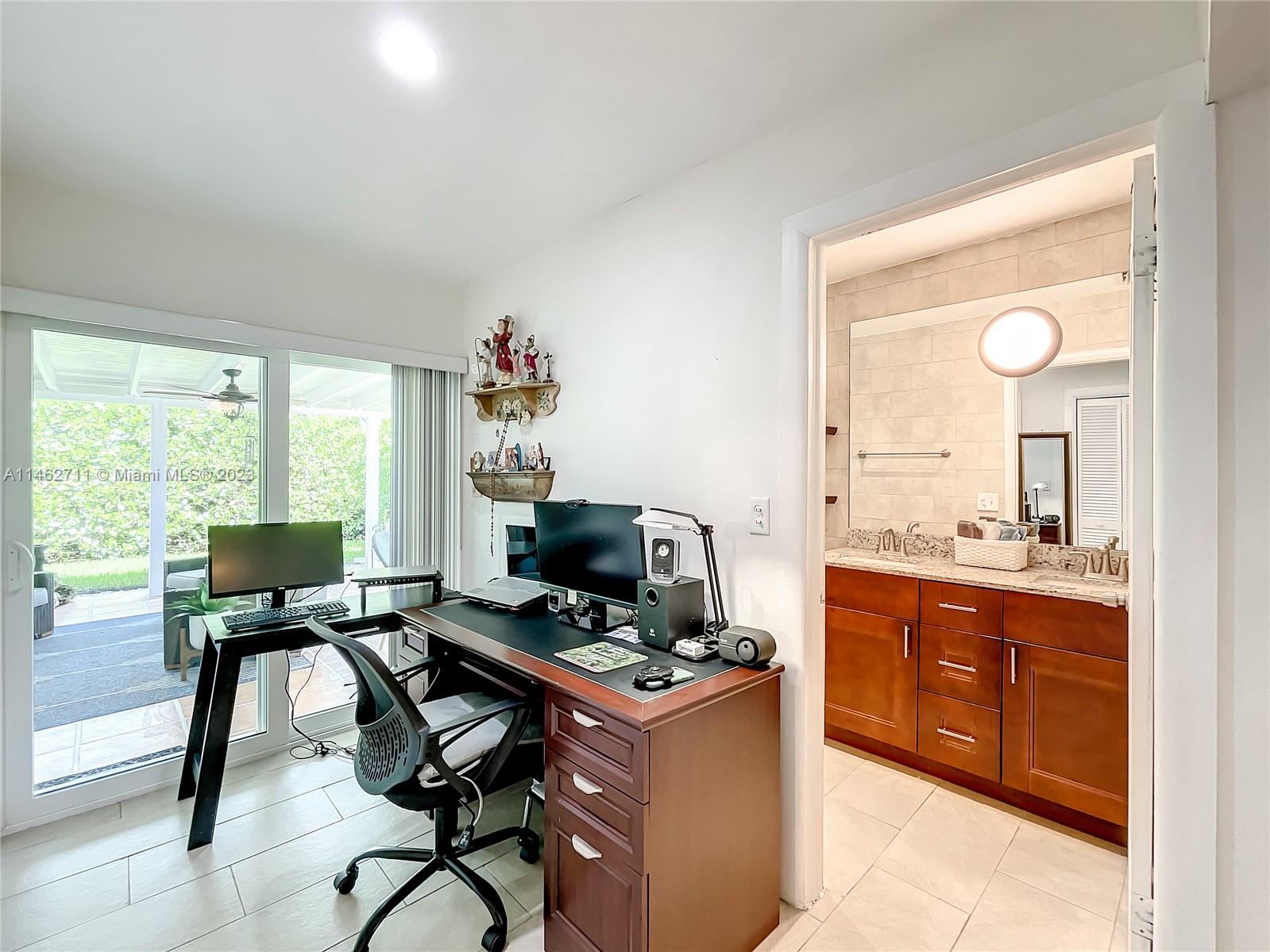 9035 Southwest 48th Terrace Miami, FL 33165 - Photo 25 of 37 a view of a workspace with furniture and a window