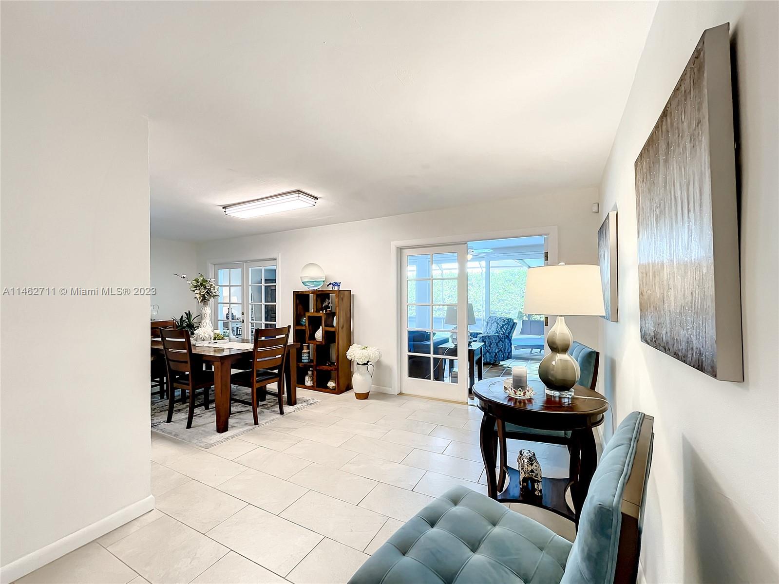 9035 Southwest 48th Terrace Miami, FL 33165 - Photo 3 of 37 a living room filled with furniture and a large window