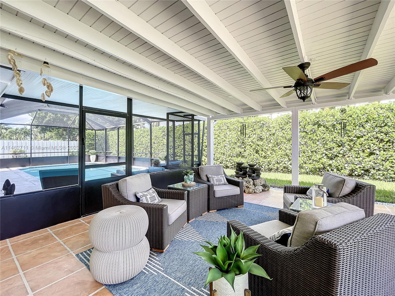 9035 Southwest 48th Terrace Miami, FL 33165 - Photo 33 of 37 a living room with patio furniture and a large window