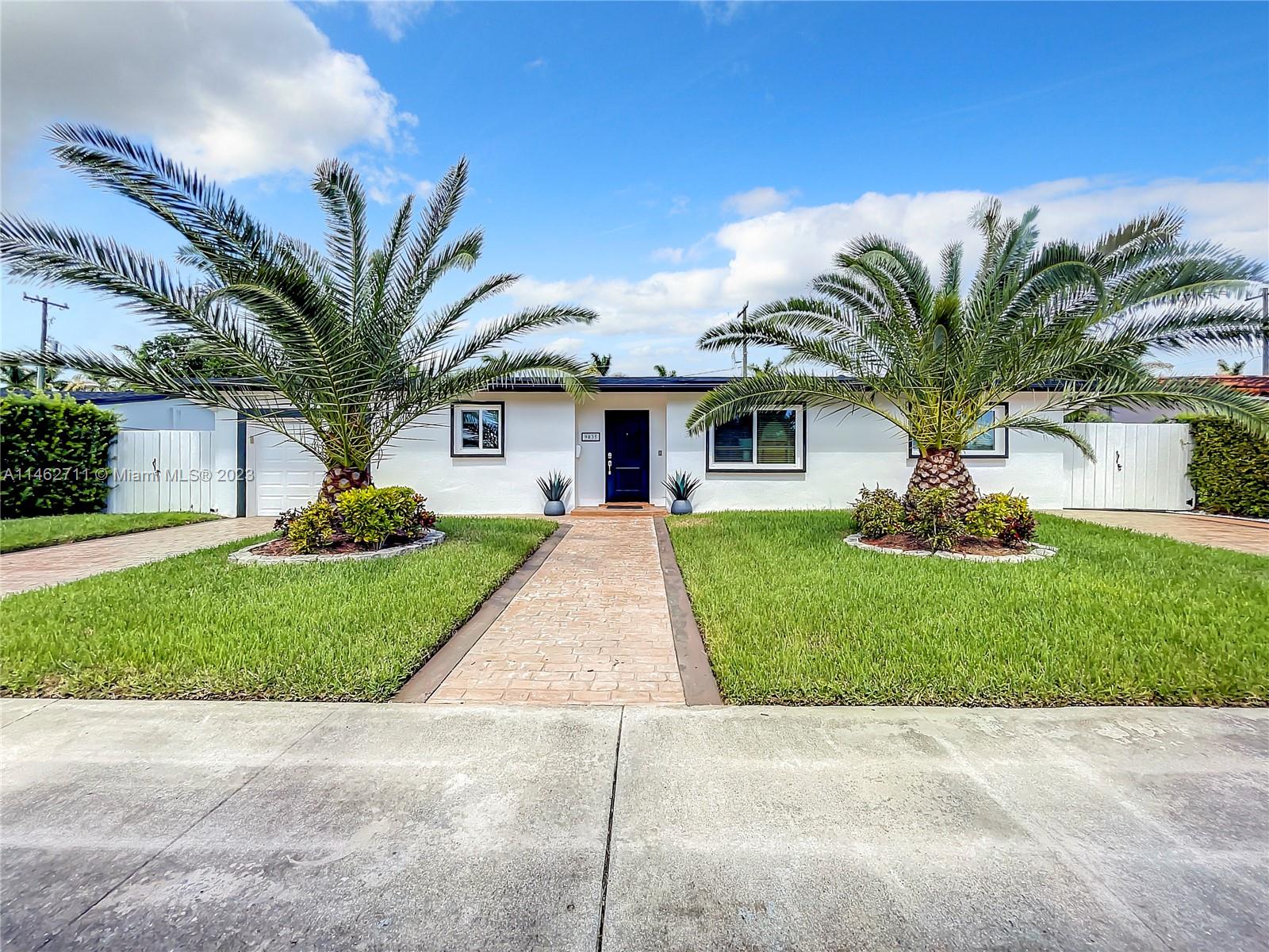 9035 Southwest 48th Terrace Miami, FL 33165 - Photo 35 of 37 a view of a house with a yard and palm trees