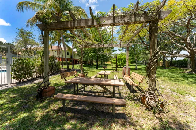a view of yard with swimming pool and sitting area
