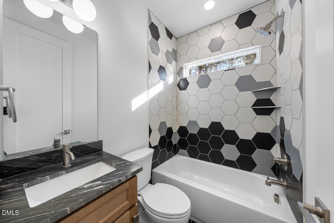 2530 West Wilson Street Durham, NC 27705 - Photo 32 of 49 a bathroom with a granite countertop bathtub sink vanity mirror and toilet