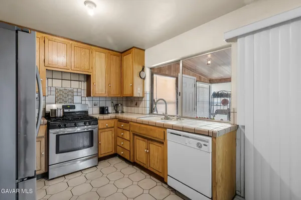 a kitchen with a sink stove and refrigerator