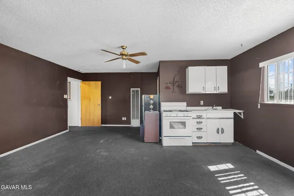 a bathroom with a granite countertop toilet and a sink