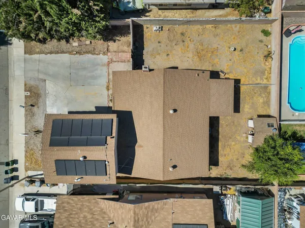 an aerial view of a residential houses with outdoor space