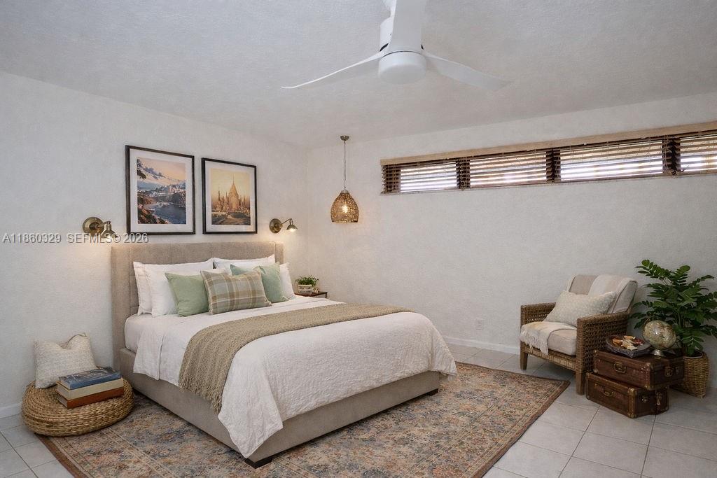 400 St Andrews Road, Unit 56 Hollywood, FL 33021 - Photo 11 of 18 a bedroom with a bed and chair