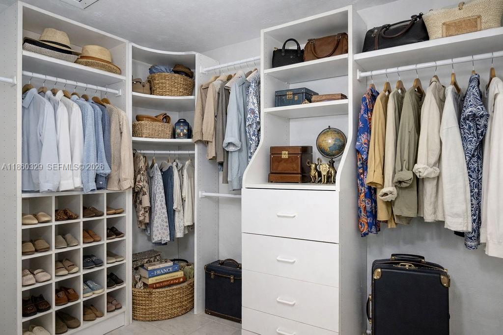 400 St Andrews Road, Unit 56 Hollywood, FL 33021 - Photo 12 of 18 a view of walk in closet with clothes and shoes