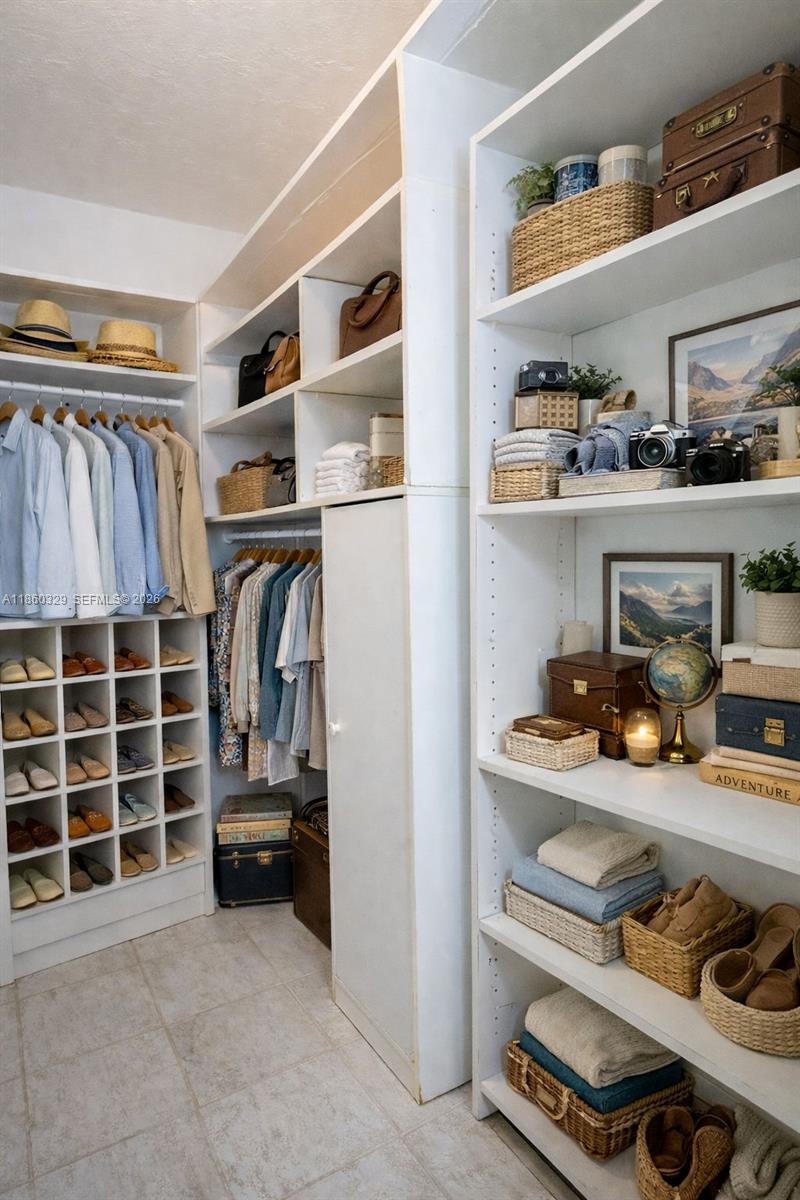 400 St Andrews Road, Unit 56 Hollywood, FL 33021 - Photo 13 of 18 a view of walk in closet with clothes and shoes