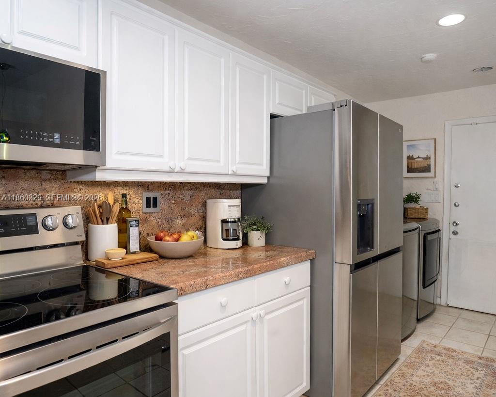 400 St Andrews Road, Unit 56 Hollywood, FL 33021 - Photo 6 of 18 a kitchen with stainless steel appliances granite countertop a refrigerator stove and microwave