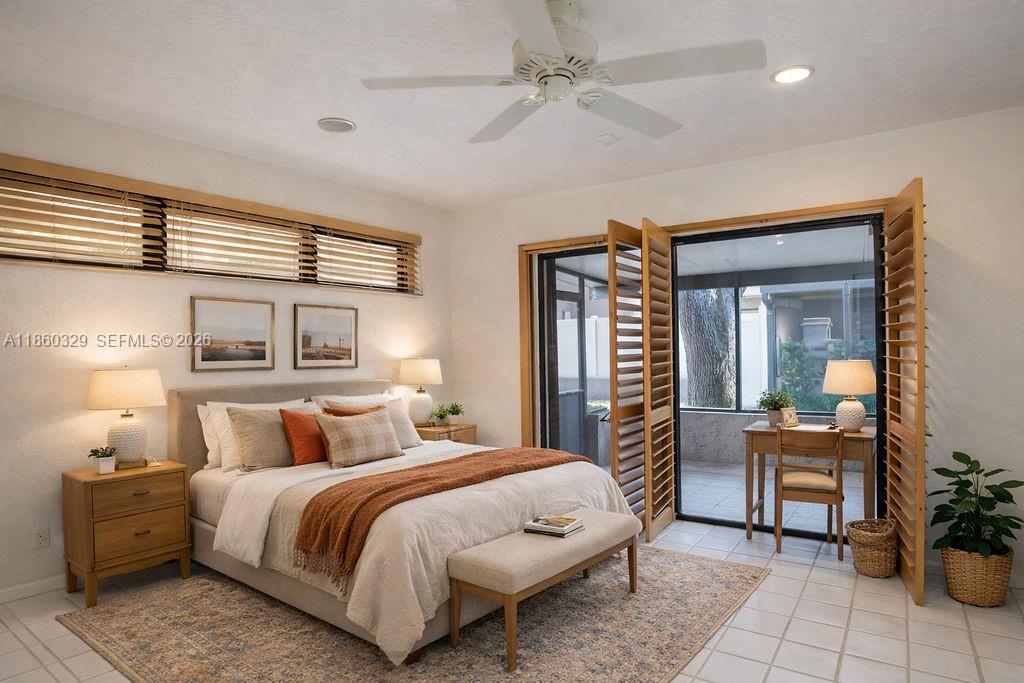 400 St Andrews Road, Unit 56 Hollywood, FL 33021 - Photo 9 of 18 a bedroom with a large bed and a chandelier