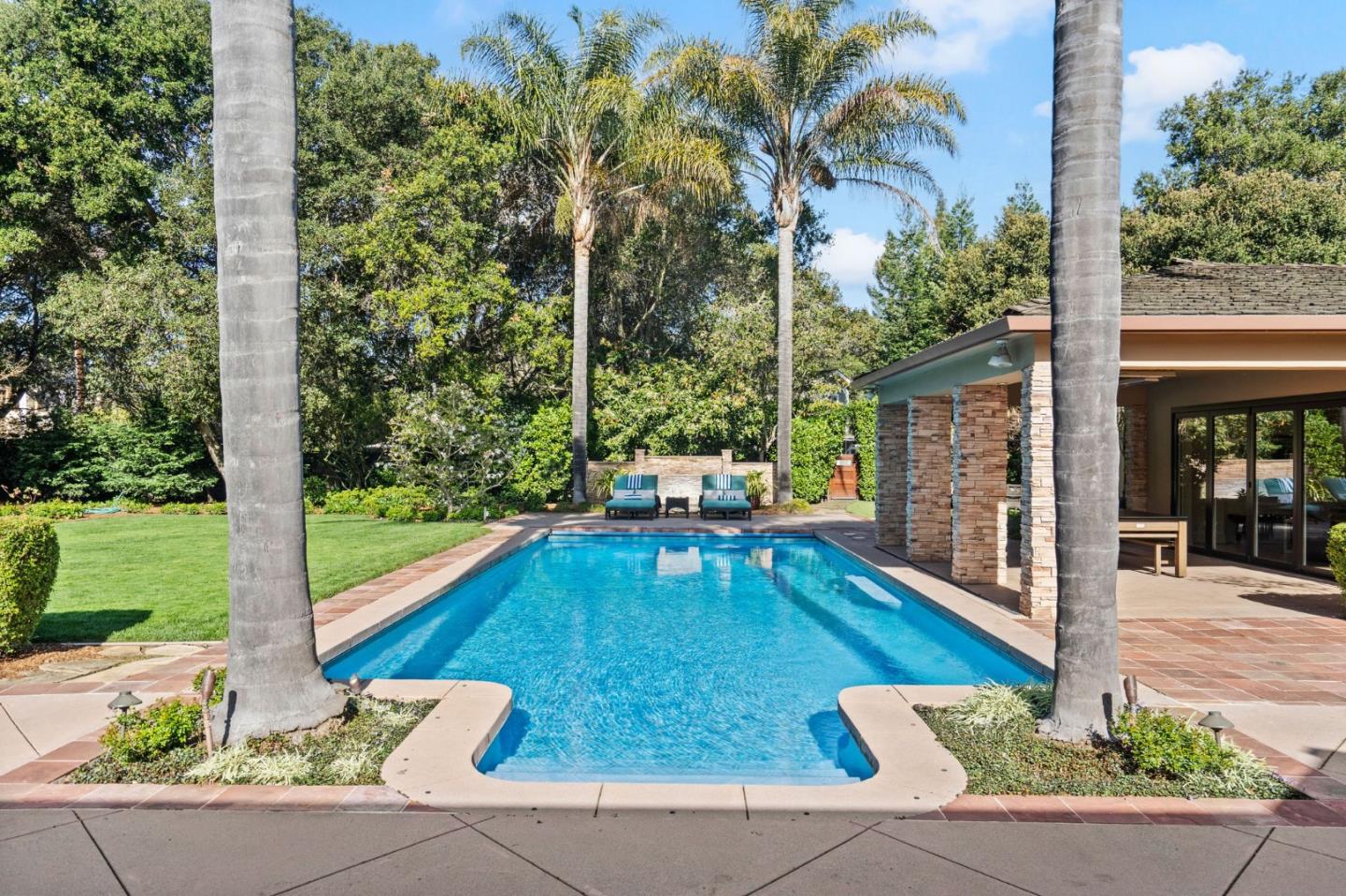 2 Lane Place Atherton, CA 94027 - Photo 2 of 35 a view of a patio with a table chairs and a floor to ceiling window