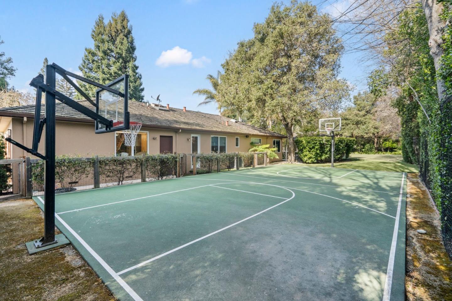 2 Lane Place Atherton, CA 94027 - Photo 35 of 35 a view of a white house next to a yard with big trees