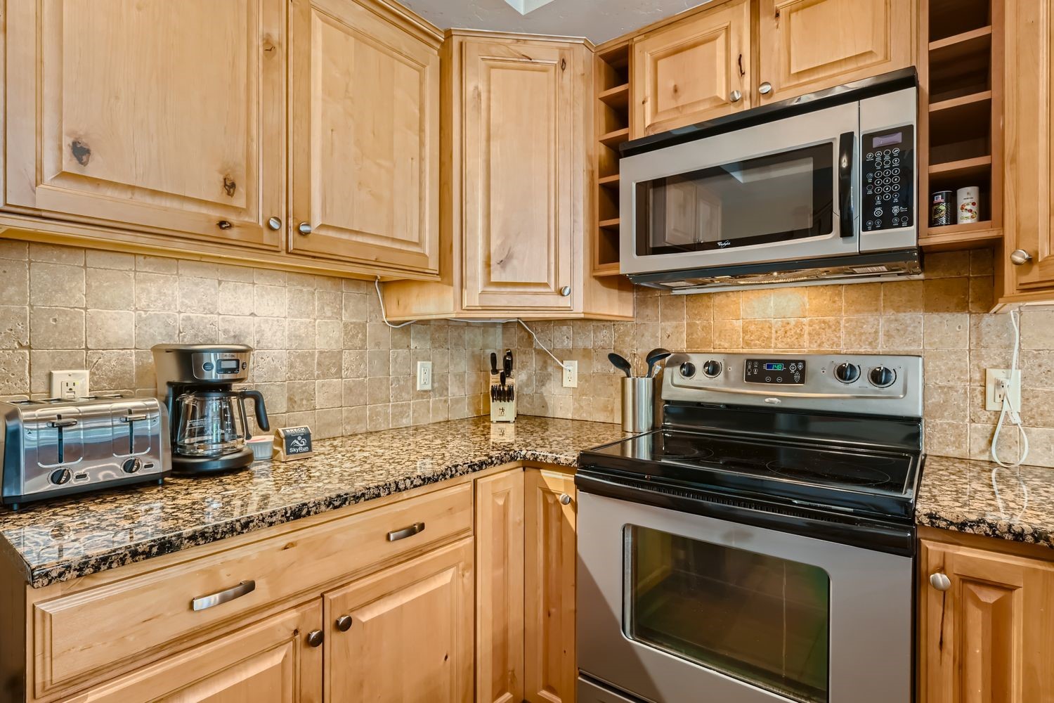 200 North Ridge Street, Unit R A Breckenridge, CO 80424 - Photo 11 of 38 a kitchen with granite countertop a sink stainless steel appliances and cabinets