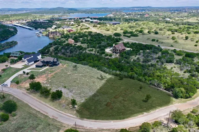 an aerial view of a residential houses with outdoor space and garden