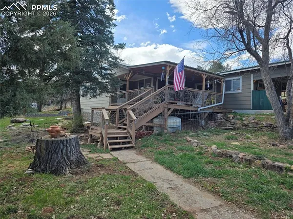 a view of a house with a yard porch and sitting area