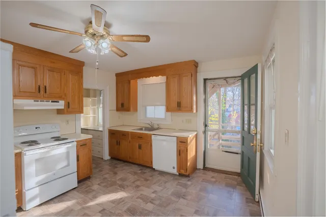 a kitchen with a stove a sink and a refrigerator
