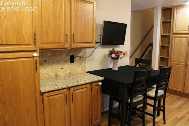 1747 Van Diest Road Colorado Springs, CO 80915 - Photo 8 of 30 Gorgeous granite, lots of cabinets, and the TV stays!