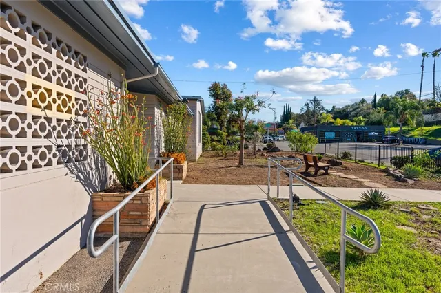 a view of a swimming pool with outdoor seating and plants
