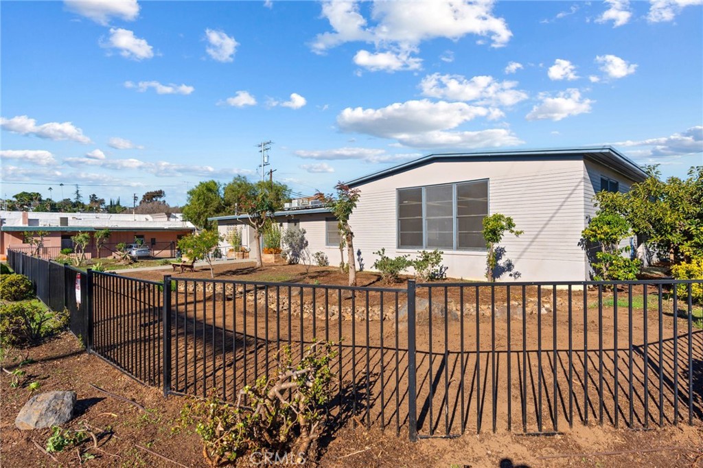 130 East Alvarado Street Fallbrook, CA 92028 - Photo 15 of 15 a view of a brick house with a flower garden