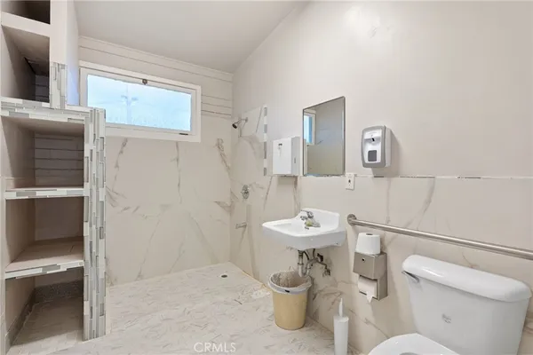 a white toilet sitting next to a bathroom sink
