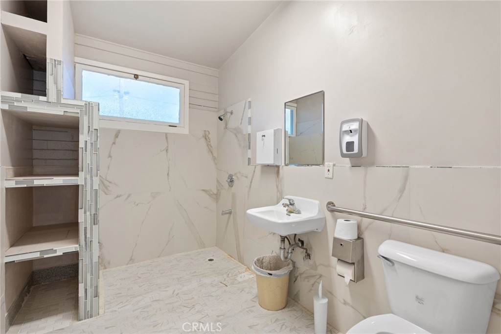 130 East Alvarado Street Fallbrook, CA 92028 - Photo 5 of 15 a white toilet sitting next to a bathroom sink