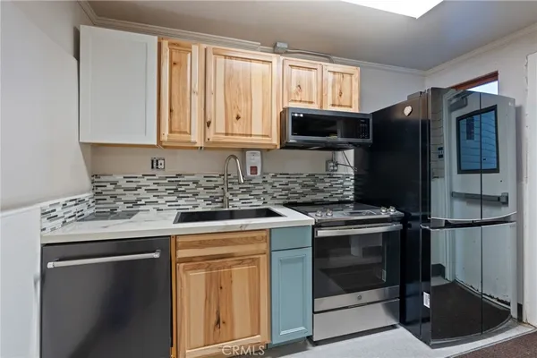 a kitchen with stainless steel appliances granite countertop a stove a refrigerator and a microwave
