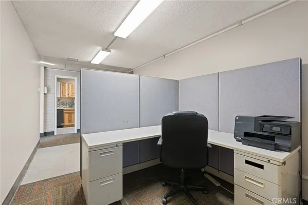 a kitchen that has a chair and a stove in it
