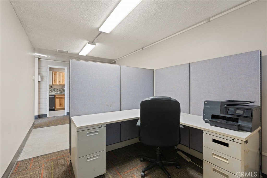 130 East Alvarado Street Fallbrook, CA 92028 - Photo 8 of 15 a kitchen that has a chair and a stove in it