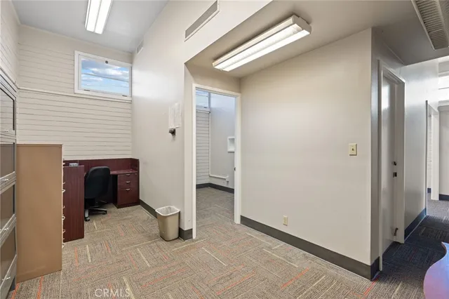 a view of a livingroom with wooden floor and furniture