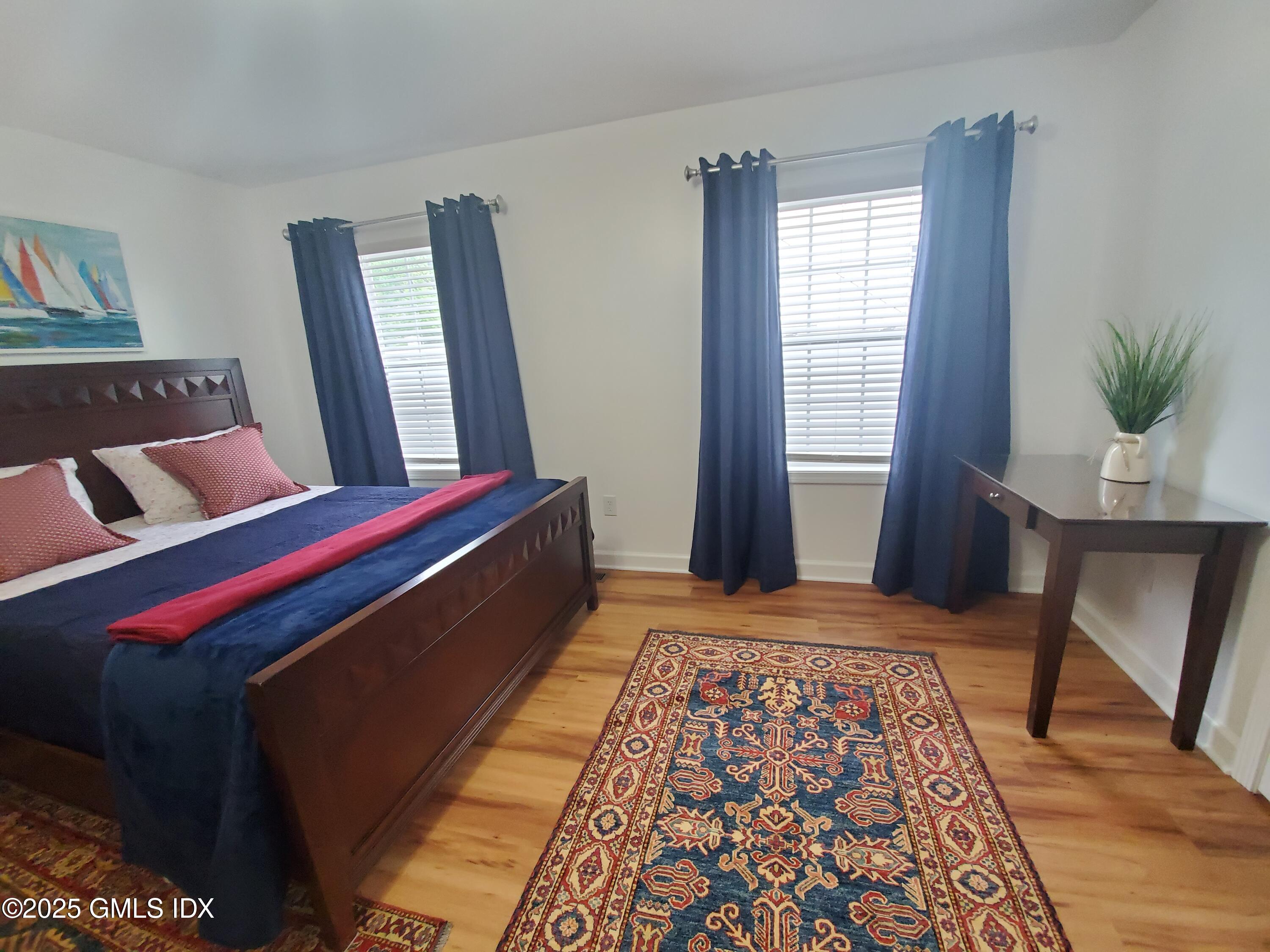 92 Valley Road, Unit A Cos Cob, CT 06807 - Photo 18 of 57 a bed room with a bed and a chair