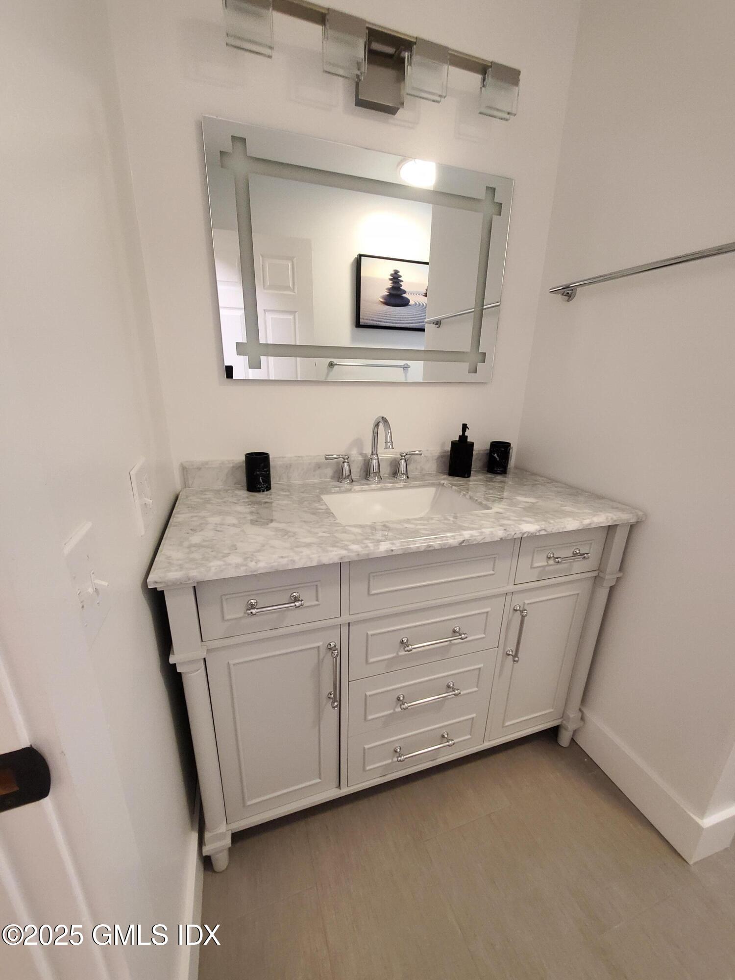 92 Valley Road, Unit A Cos Cob, CT 06807 - Photo 21 of 57 a bathroom with a double vanity sink and mirror
