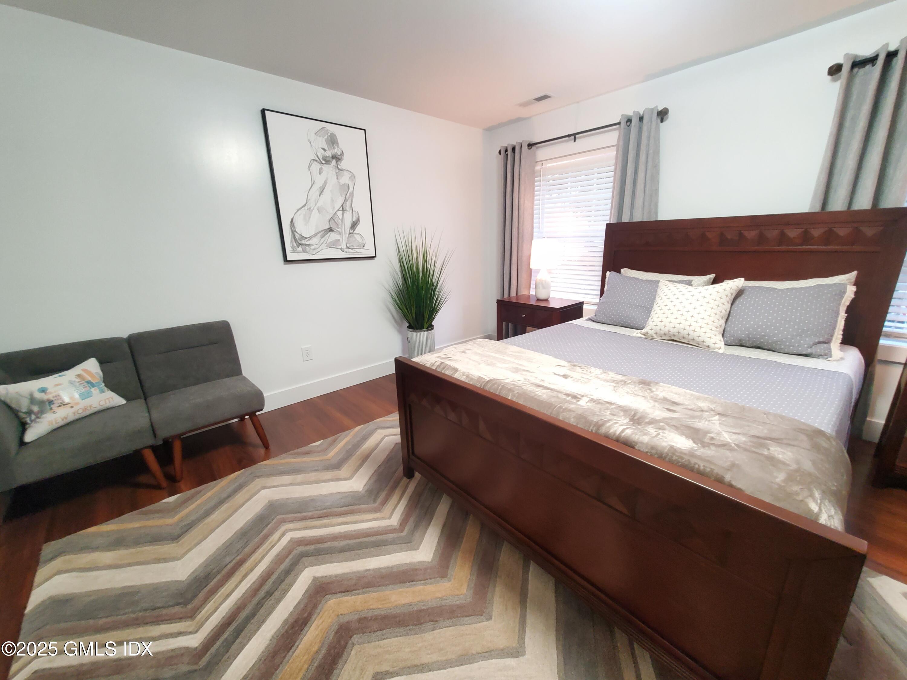 92 Valley Road, Unit A Cos Cob, CT 06807 - Photo 24 of 57 a bedroom with a large bed and a couch