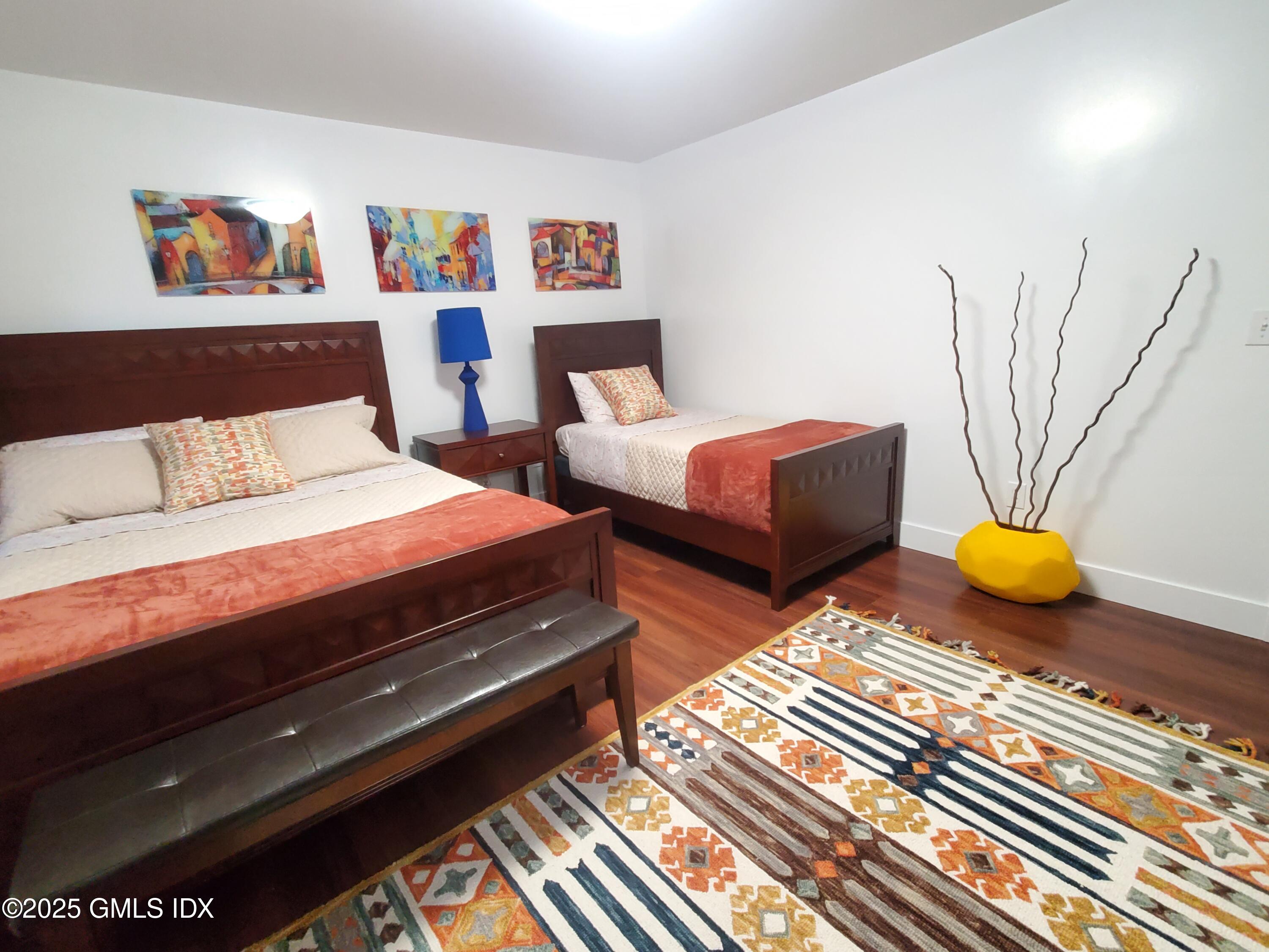 92 Valley Road, Unit A Cos Cob, CT 06807 - Photo 28 of 57 a bedroom with two beds and painting on the wall