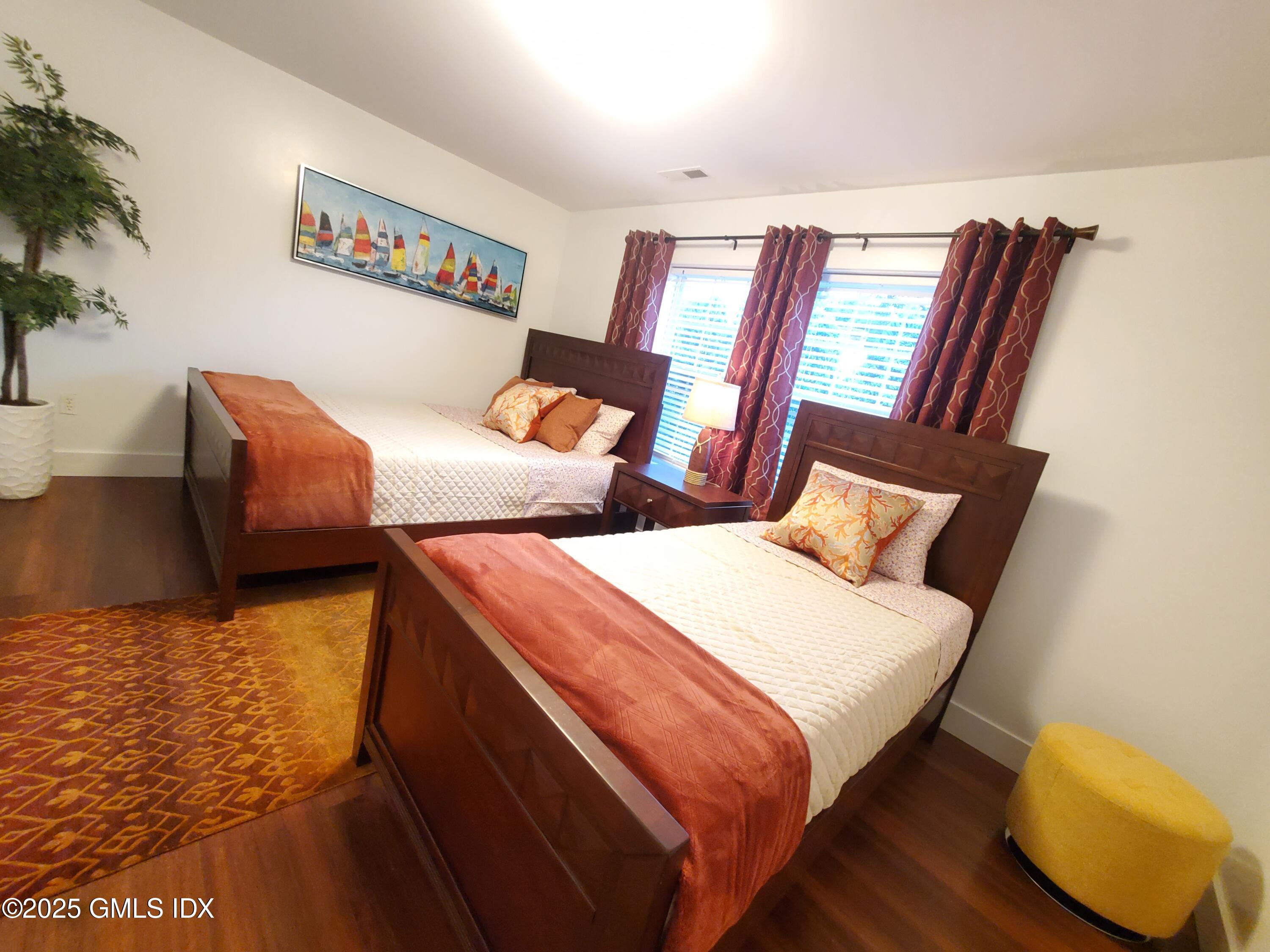 92 Valley Road, Unit A Cos Cob, CT 06807 - Photo 31 of 57 a bedroom with furniture and a rug