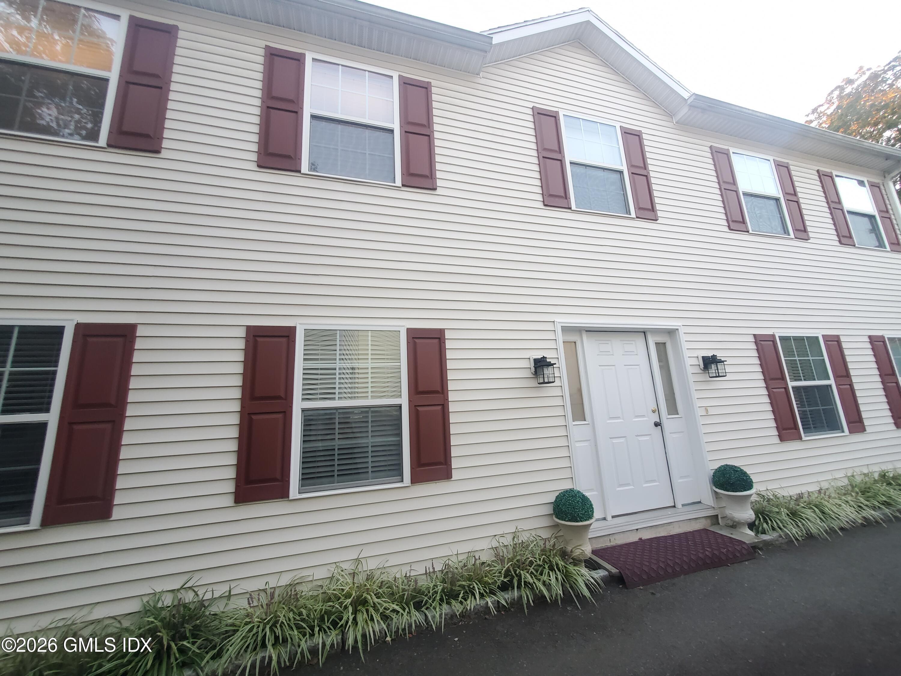 92 Valley Road, Unit A Cos Cob, CT 06807 - Photo 45 of 57 a front view of a house with a yard