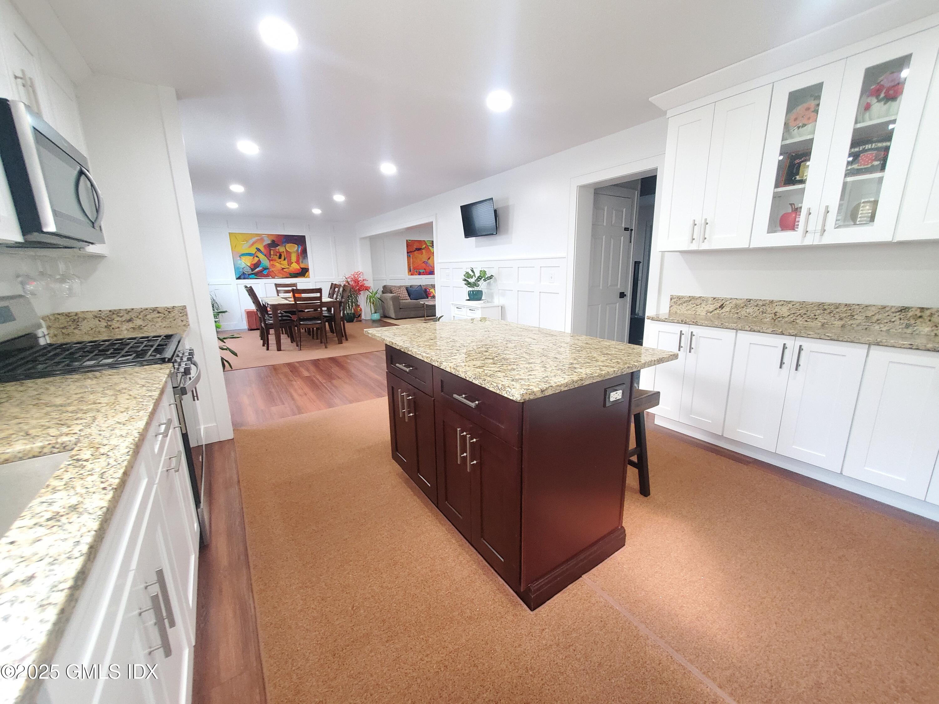 92 Valley Road, Unit A Cos Cob, CT 06807 - Photo 10 of 57 a spacious kitchen with stainless steel appliances granite countertop plenty wooden cabinets counter space and wooden floor